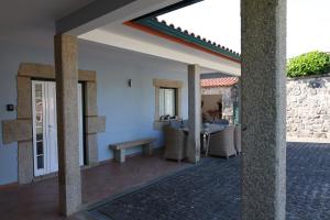 a view from the outside of a house with a patio at Qt Refúgio de Rubiães Villa 1-2 Paredes de Coura in Paredes de Coura