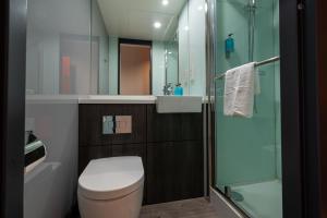 a bathroom with a toilet and a glass shower at easyHotel Dublin in Dublin