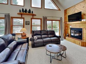 a living room with leather furniture and a fireplace at Almost Heaven in Swanton