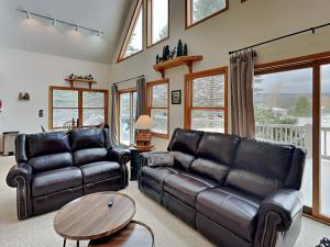 a living room with two leather couches and a table at Almost Heaven in Swanton