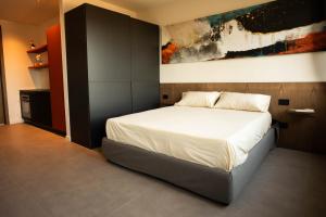 a bedroom with a bed with a painting on the wall at Sicilias in Catania