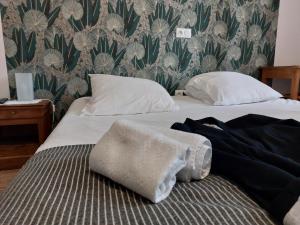 a bed with white sheets and towels on it at Couvent de Vaylats in Vaylats