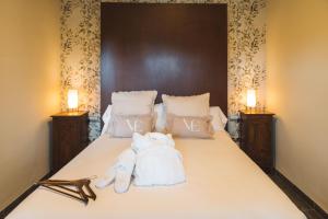 En eller flere senge i et værelse på Hotel Boutique Villa Emilia