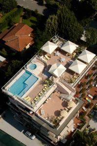 a large white building with a blue sky at Hotel Residence Villa Marzia in Marina di Pietrasanta