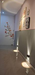 a room with two lights on a wall with paintings at Cozy Nook in George Town