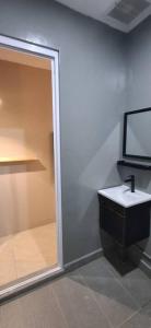 a bathroom with a sink and a shower at Cozy Nook in George Town +52 photos