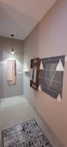 a bathroom with a mirror and towels on a wall at Cozy Nook in George Town