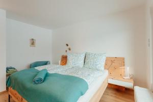 a bedroom with a bed with a blue ribbon on it at Haus MARGOT by MoniCare in Seefeld in Tirol