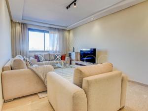a living room with two couches and a tv at Iris Agadir - Luxe - Piscine - 4 Px in Agadir