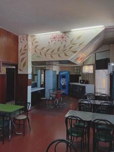 a restaurant with tables and chairs in a room at Alojamiento Avellaneda in Rosario