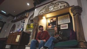 a man and a woman sitting on a couch at High Street Hostel - Over 18s Only, Backpackers Atmosphere in Edinburgh