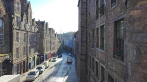 a view of a city street with buildings and cars at High Street Hostel - Over 18s Only, Backpackers Atmosphere in Edinburgh