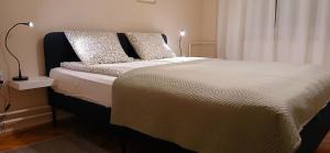 a bed with two pillows on it in a bedroom at Apartman Rada in Pirot