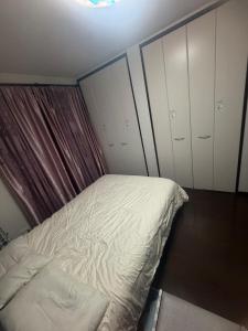 a bedroom with a bed and some closets at sakuraの家 in Tokyo