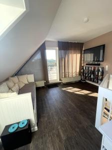 a large living room with a couch and a window at Haus Seeburg Appartement 2.6 - strandnah in Scharbeutz