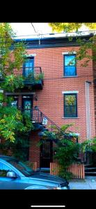 a red brick building with a staircase in front of it at La Pause Montréal in Montreal