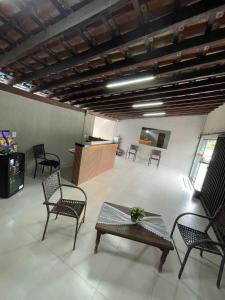 a large room with chairs and a table and a table sidx sidx sidx at Pousada das Flores in Aparecida