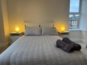 a bedroom with a bed with two lamps on it at Central Aldershot Flat, Near Station & Town Centre in Aldershot