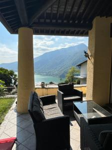 a patio with couches and a view of a mountain at Rovio Villa lake View & Relax, Lago di Lugano 4guests in Lugano