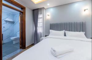 a bedroom with a large bed and a bathroom at Emerald Greens 3-Bedroom House in Thika