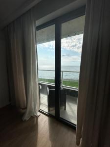 a room with a large window with a view of the ocean at bamboo beach in Buknari