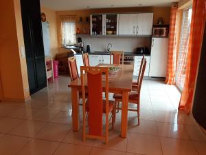 eine Küche mit einem Tisch und Stühlen sowie eine Küche mit weißen Schränken in der Unterkunft Ferienhaus direkt am See in Blankensee