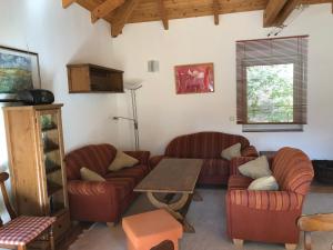 a living room with two couches and a table at Ferienhaus am Plauer See in Lenz