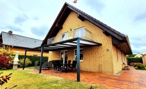 a large house with a patio and a roof at Ferienwohnung am Plauer See in Alt Schwerin