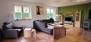 a living room with a couch and a tv at Ferienwohnung am Plauer See in Alt Schwerin