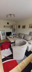 un soggiorno con un divano e un tavolo di Ferienhälfte Insel Rügen a Glowe Altre 7 foto