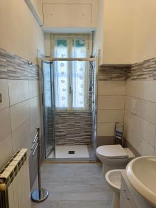 a bathroom with a shower and a toilet and a sink at Casa Quintina in Lamezia Terme +15 photos
