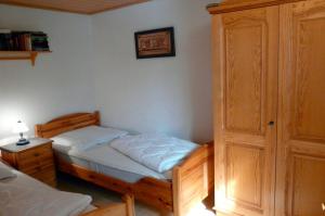 a bedroom with two twin beds and a cabinet at Ferienhaushälfte Fleesensee in Silz
