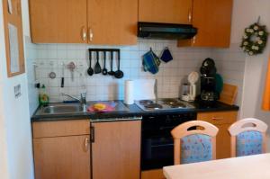 a small kitchen with a stove and a sink at Ferienhaushälfte Fleesensee in Silz