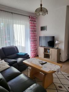 een woonkamer met een bank en een tafel bij Ferienwohnung Zühlensee in Wesenberg