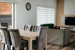 a living room with a wooden table and chairs at Disa Close 3 Cathkin Estates in Winterton