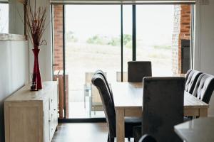 a dining room with a wooden table and chairs at Disa Close 3 Cathkin Estates in Winterton
