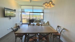 a living room with a table and chairs and a couch at Departamento Costa Pucón in El Cerrillo