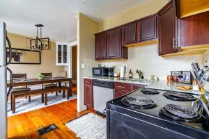 a kitchen with a stove and a dining room at Jungle House Luxury Stays - Columbus Downtown Short North in Columbus