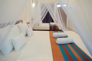 En eller flere senge i et værelse på Urban Tide Dickwella