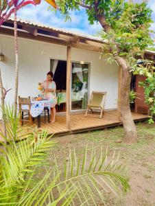 a woman sitting at a table outside of a house at Cabaña Itia in Hanga Roa +18 photos
