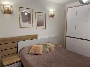 a bedroom with a bed with two furry pillows on it at Modern Apartment in Tecuci