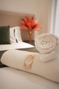 a towel with a drawing on it sitting on a bed at Duse Luxury Stay in Milan
