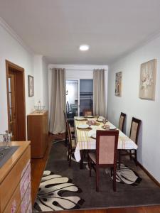 a dining room with a table and chairs at LandS in Caniço