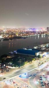 a view of a city at night with a bridge and traffic at Sea View Holiday Home with Parking in Ajman 
