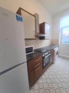 a kitchen with a refrigerator and a dishwasher at Modern Studios in Sunderland