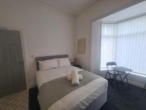 a bedroom with a bed with a stuffed animal on it at Modern Studios in Sunderland +2 photos