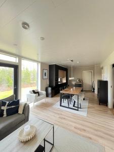 a living room with a couch and a table at Villa Aurora Noir in Rovaniemi