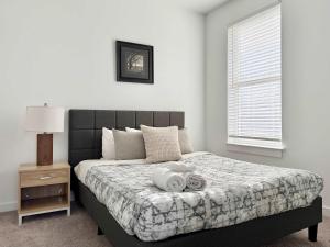 a bedroom with a bed with a tray of towels on it at New 1B1B Condo in Old Fourth Ward 542Blvd207 in Atlanta