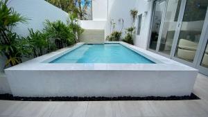 a swimming pool in front of a house at Stella w Pool Dorado Beach Resort 4BR in Mameyal