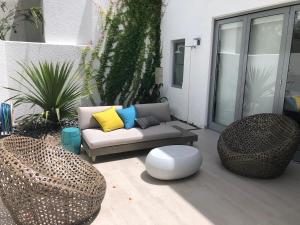 a patio with a couch and two chairs at Stella w Pool Dorado Beach Resort 4BR in Mameyal